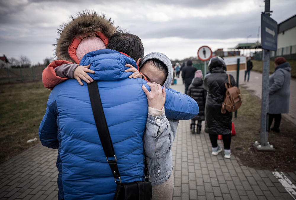 A man hugs his daughter and grandaughter after they crossed the border from Shehyni in Ukraine to Medyka in Poland. Numerous Ukrainians are leaving the country fleeing the conflict. DEC’s Ukraine Humanitarian appeal launched on 3rd March 2022, and has been supported by Pennies merchants including Domino’s, Euro Car Parts, Adnams and Rontec.