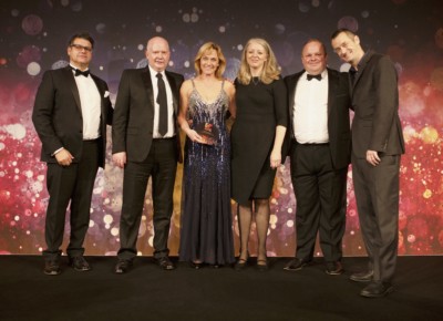 Alison Huitchinson CBE, centre, stands beside the team from K3Retail and Hobbycraft on the EPA awards stage